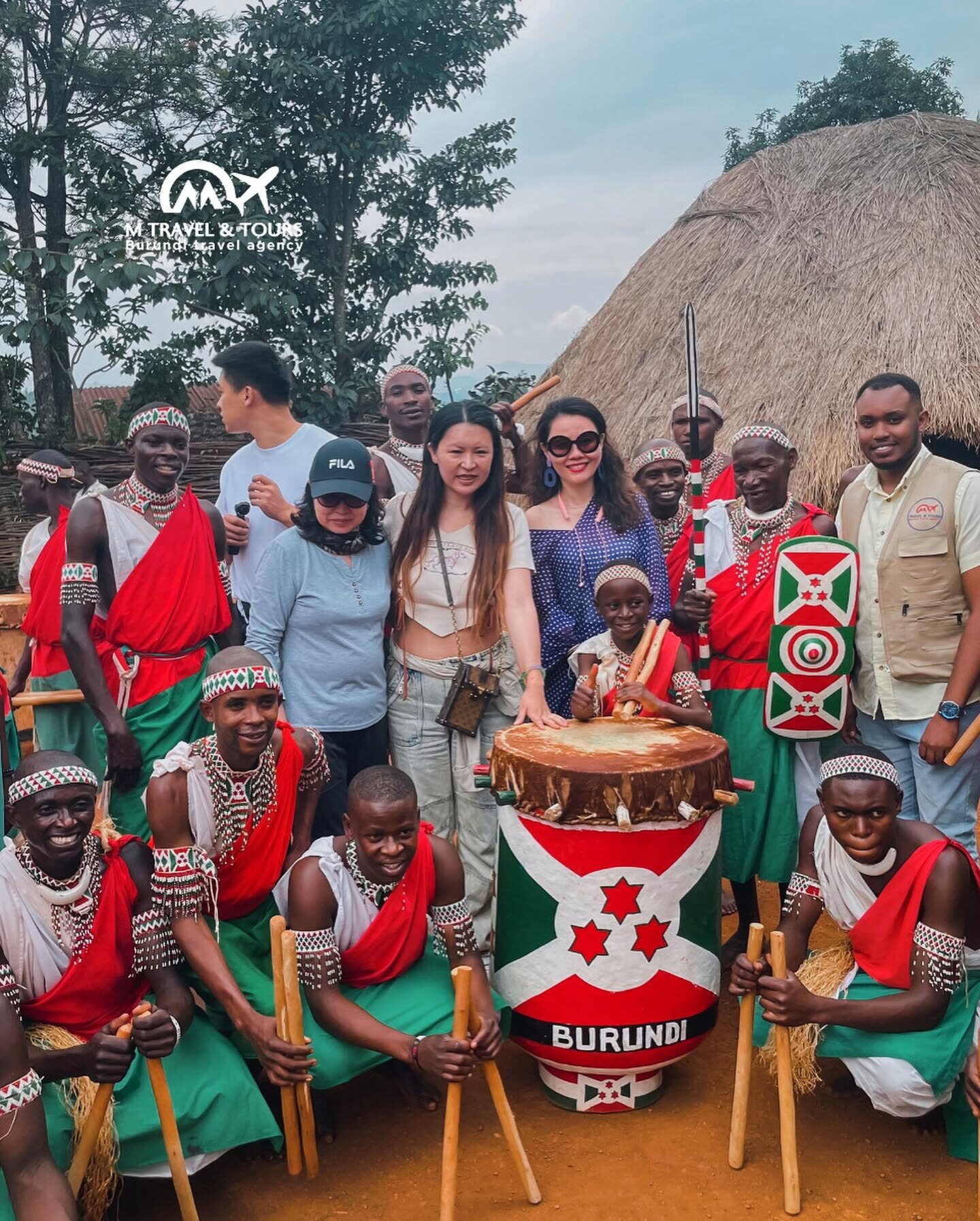 M Travel guests and Burundian royal drummers around the central drum